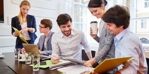 Start-up,Team,Discussing,And,Cooperating,In,Business,Meeting